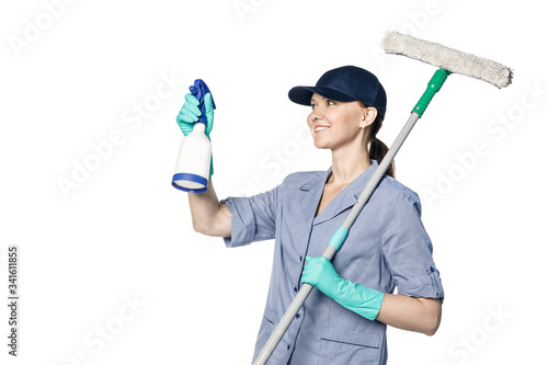 Brunette girl in a baseball cap and cleaning lady uniform washing a window with a special mop Isolated on a white background.