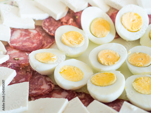 Traditional Neapolitan refreshment dish served for Easter lunch - salami, salted ricotta and hard boiled eggs cut in halves.