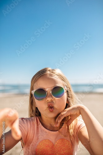 Cute girl in sunglasses making a funny face