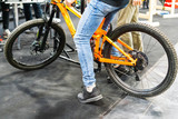 Young man in jeans sits on a bicycle