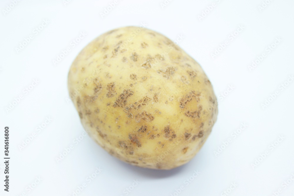 Raw ripe potatoes are located on a white background Raw ripe potatoes are located on a white background