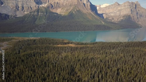 Aerial reveal, Pulpit Peak and surrounding Rockies reflecting in the calm waters of Hector Lake, Alberta Canada photo