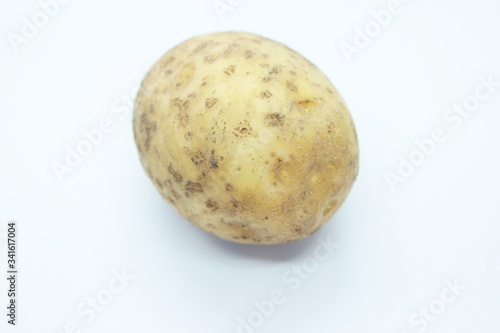 Raw ripe potatoes are located on a white background