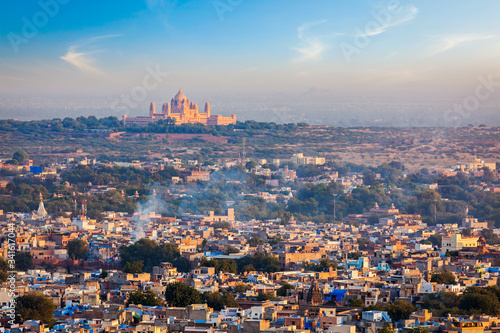 Aerial view of Jodhpur cityscape - the Blue city - with Umaid Bhawan Palace on horizon on sunset. View from Mehrangarh Fort. Jodphur, Rajasthan, India photo