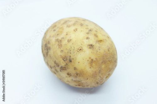 Raw ripe potatoes are located on a white background
