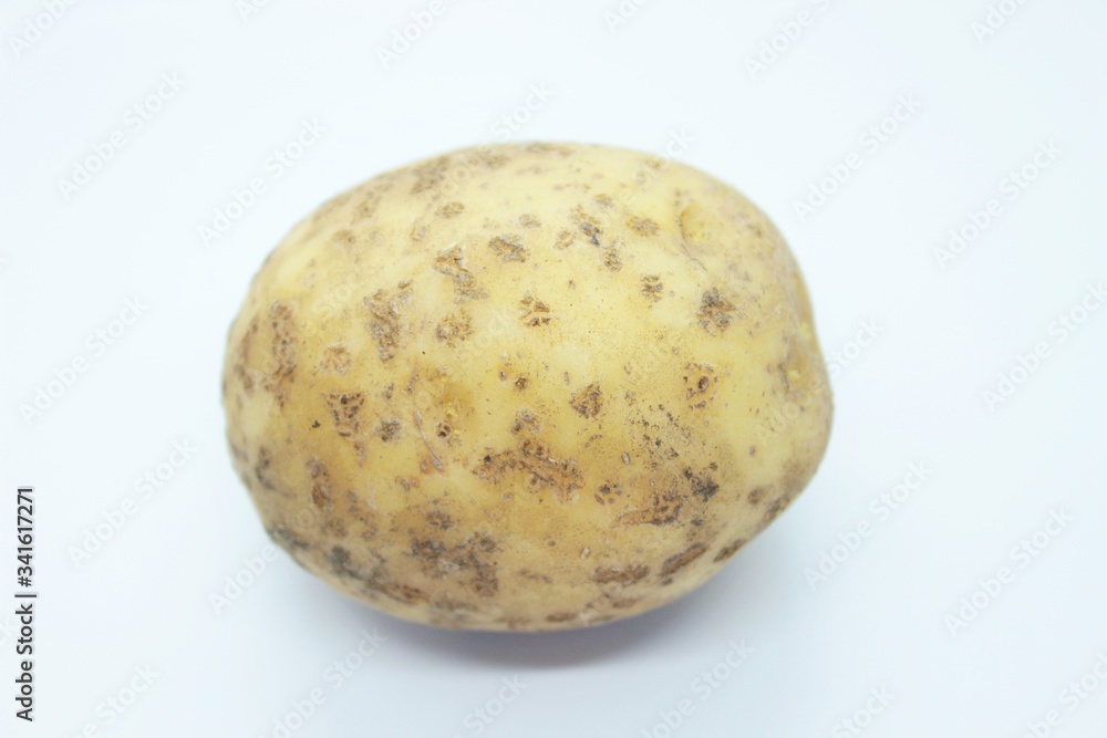 Raw ripe potatoes are located on a white background Raw ripe potatoes are located on a white background