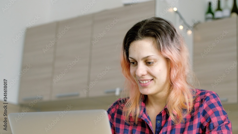 Positive russian woman working on laptop computer looking in monitor. Thoughtful woman search for inspiration make decision feel lack of ideas, stay at home in quarantine due to coronavirus 