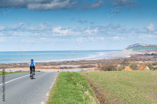 Cyclist on a road in the Opal Coast, France, Pas de Calais