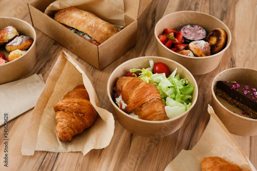 Quadro su tela Different takeout food on wooden kitchen table