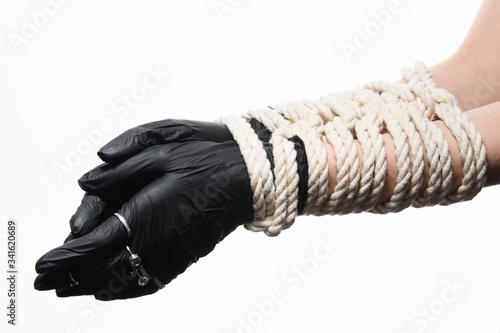 Kinbaku Shibari women's hands tied with rope wearing medical gloves