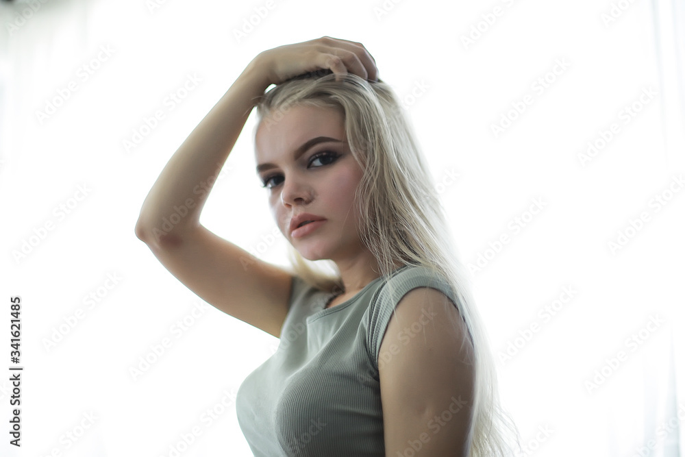 young adult blonde long hair at home, stylish model posing in the studio young adult blonde long hair at home, stylish model posing in the studio
