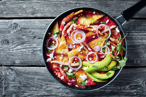 chilaquiles with ham, cheese, avocado, top view photo