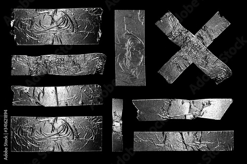 Adhesive Aluminum Silver Metal Foil Scotch Sticky Tape Pieces. Isolated Torn Shabby Rough Authentic Elements Set on a Black Background. photo