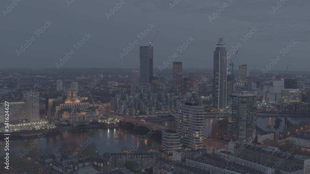 Vauxhall Cross and SIS Building Aerial decent shot at dusk. Aerial, drone descent reveals more buildings, offices and homes. River Thames and Central London. Needs colour grading. Vauxhall Cross and SIS Building Aerial decent shot at dusk. Aerial, drone descent reveals more buildings, offices and homes. River Thames and Central London. Needs colour grading.