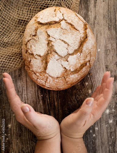 Obraz na płótnie fresh home-made bread. rustic atmosphere. on the background of the old table w salonie