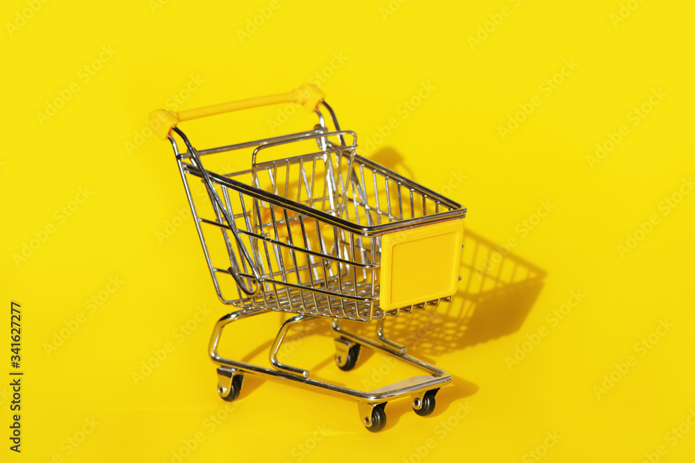 Shopping cart on yellow background. Shopping cart on yellow background.