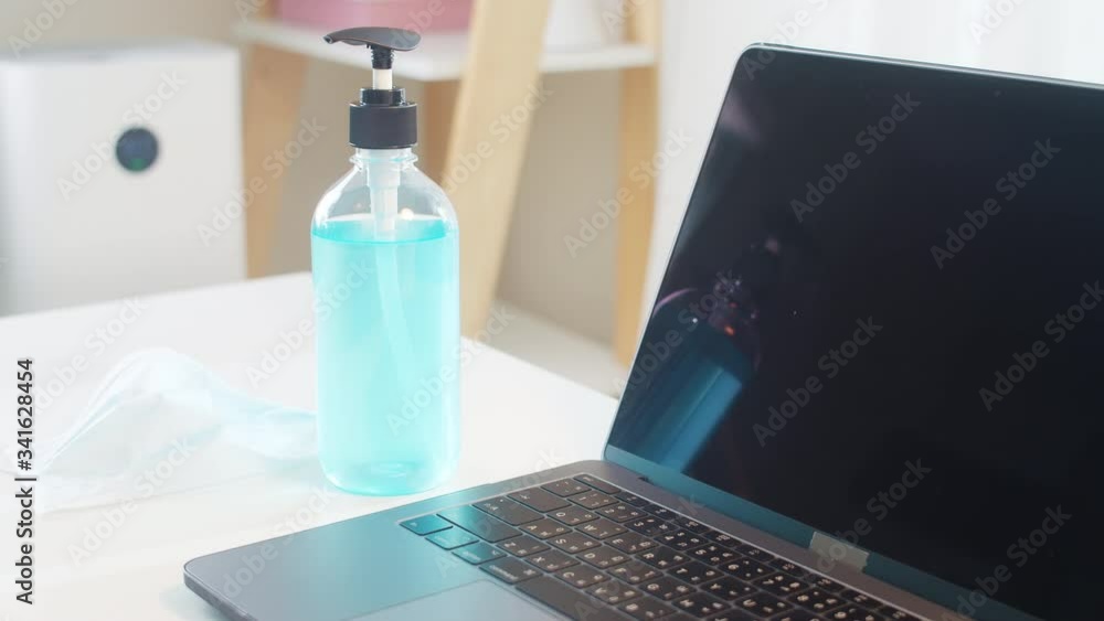 Hand sanitizer gel for hand hygiene corona virus protection with tablet, laptop and prevention medical surgical masks. Social distancing stay at home and self quarantine time, coronavirus concept. Hand sanitizer gel for hand hygiene corona virus protection with tablet, laptop and prevention medical surgical masks. Social distancing stay at home and self quarantine time, coronavirus concept.