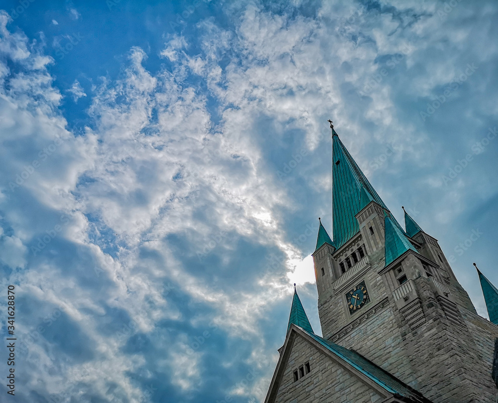 Tower of old Cathedral building in Wroclaw City with beautiful cloudy sky as background