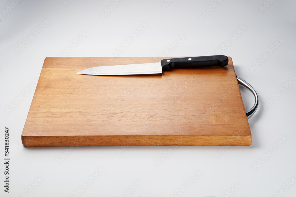 Knife on chopping board isolated over white background