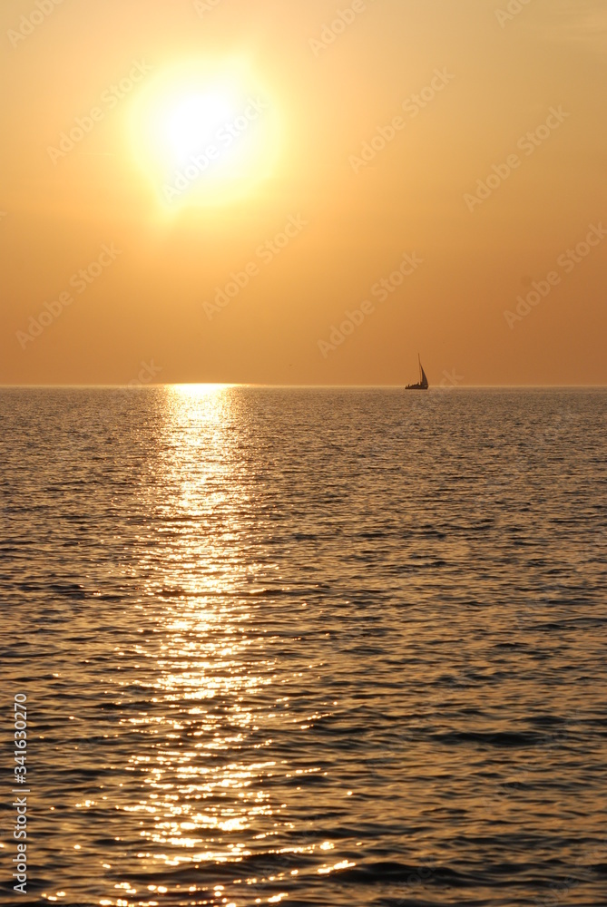 Sailboat at sea at sunset