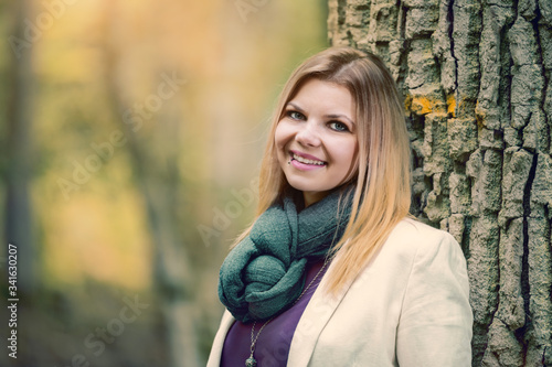 young woman standing in the fall forest