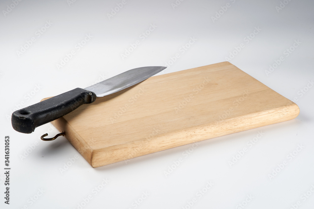 Knife on chopping board isolated over white background
