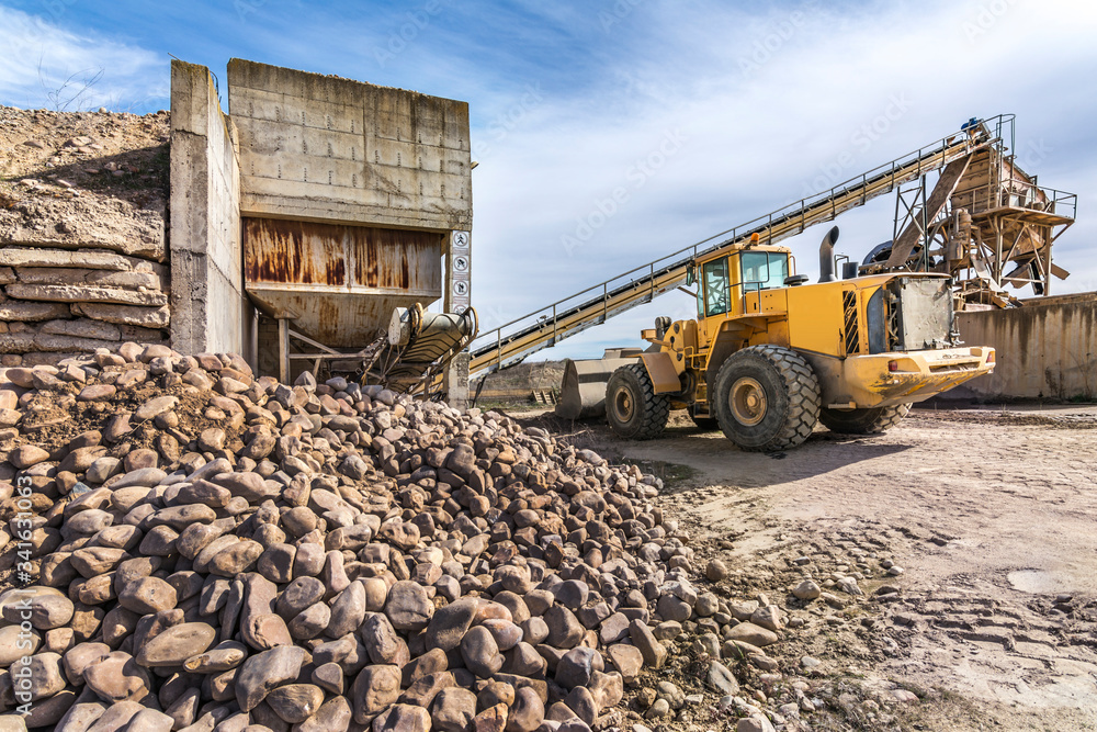 Fototapeta premium Quarry aggregate with heavy duty machinery.