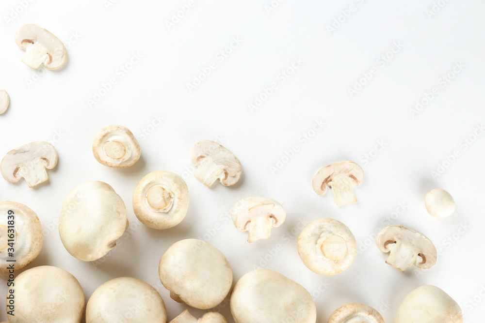 Bunch of farm raised organic mushrooms laid in composition on textured background. Champignons on table counter. Clean eating concept. Background, close up, flat lay, top view. Bunch of farm raised organic mushrooms laid in composition on textured background. Champignons on table counter. Clean eating concept. Background, close up, flat lay, top view.