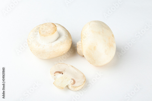 Bunch of farm raised organic mushrooms laid in composition on textured background. Champignons on table counter. Clean eating concept. Background, close up, flat lay, top view.