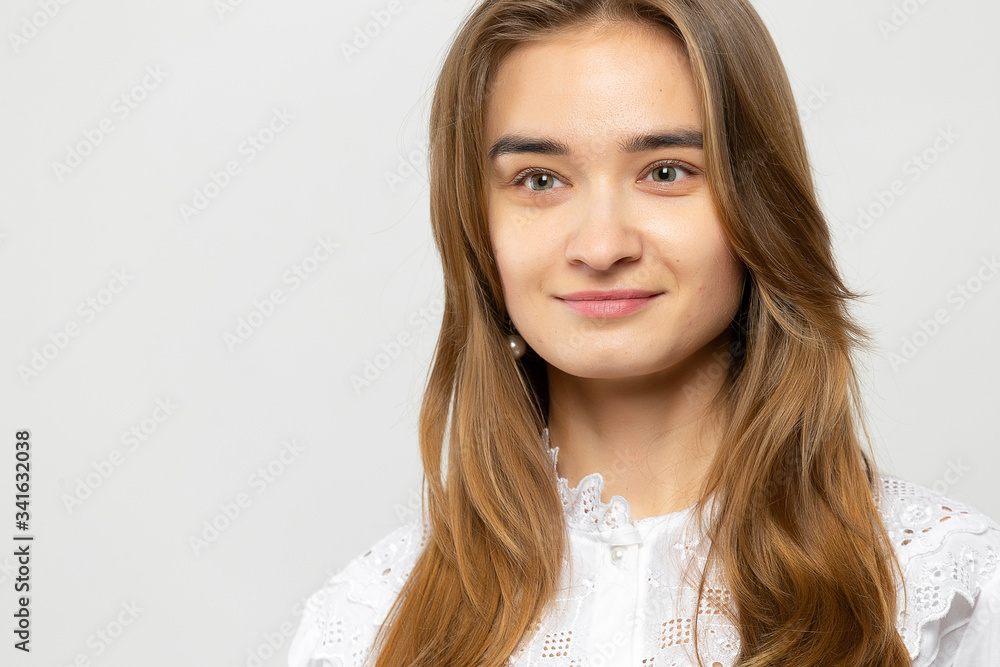 Beautiful young woman portrait. Studio shot, isolated on gray background Beautiful young woman portrait. Studio shot, isolated on gray background