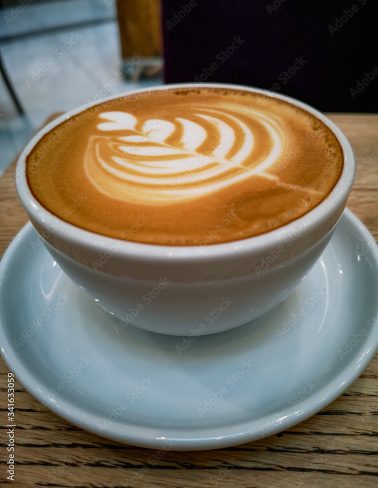 Tulip latte art on cafe latte on wooden table Tulip latte art on cafe latte on wooden table