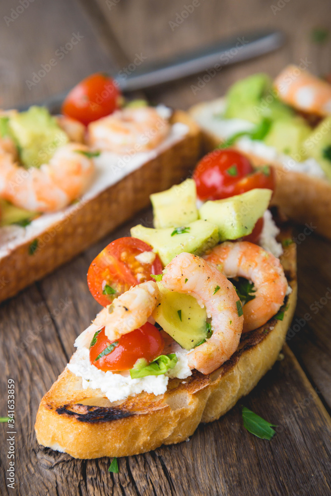 Sandwich with vegetables and prawns. Bruschetta with avocado and shrimp Sandwich with vegetables and prawns. Bruschetta with avocado and shrimp