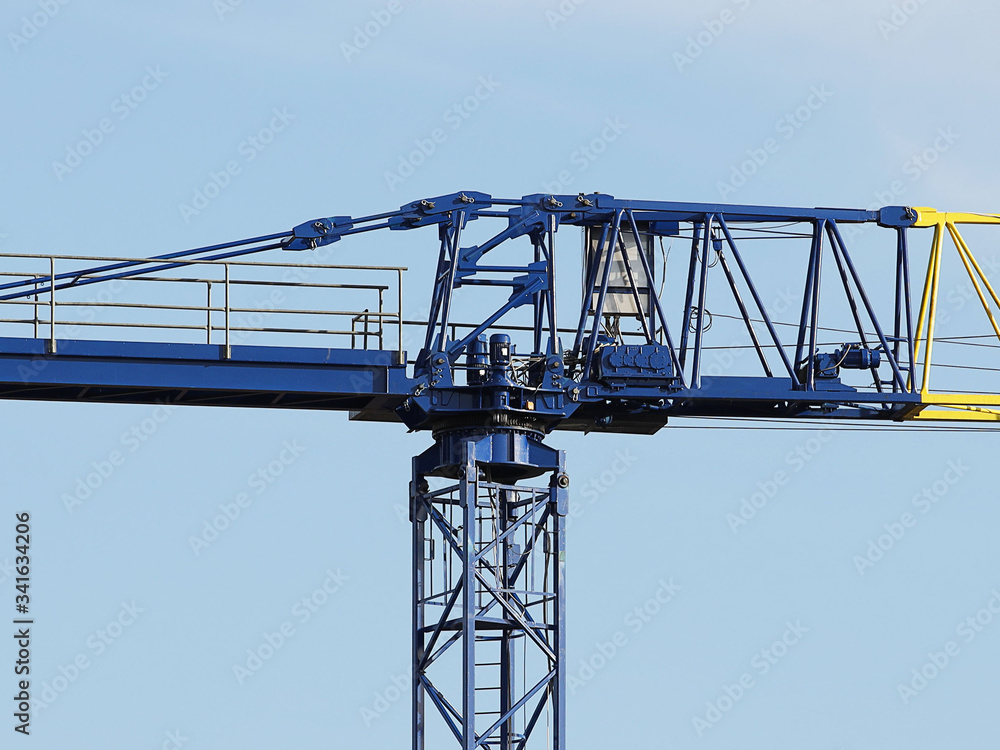 Tower cranes work during the construction of a multi-story building. New apartments for residents and premises for offices. Risky work at height. Lifting heavy building materials. City development Tower cranes work during the construction of a multi-story building. New apartments for residents and premises for offices. Risky work at height. Lifting heavy building materials. City development