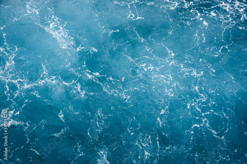 Blue ocean water texture, surface. Top view of aqua blue clear sea ocean. Beautiful blue sea water background.