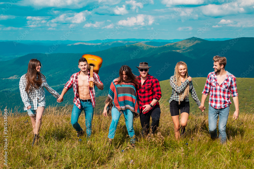 Group camping. Friends on a camping trip walking near lake, back view. Mountains tourist. Group camping. Friends on a camping trip walking near lake, back view. Mountains tourist.