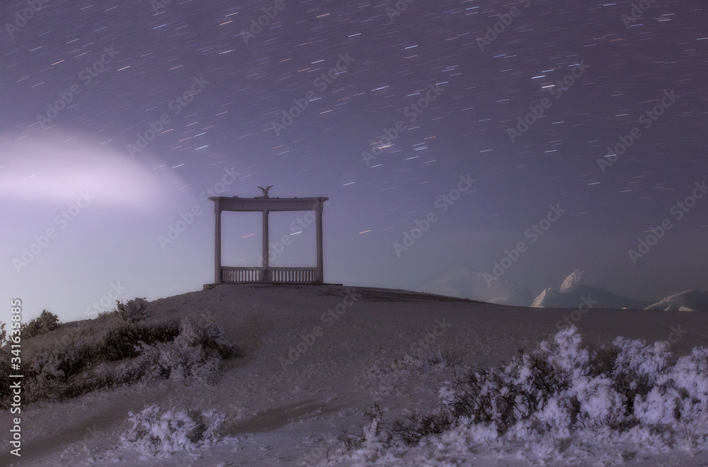 Night winter landscape with stars and an arch in the mountains Night winter landscape with stars and an arch in the mountains