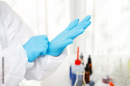 Researcher or scientists wear gloves before working in laboratory. Researchers are developing vaccines and medicine to treat the COVID-19 virus.
