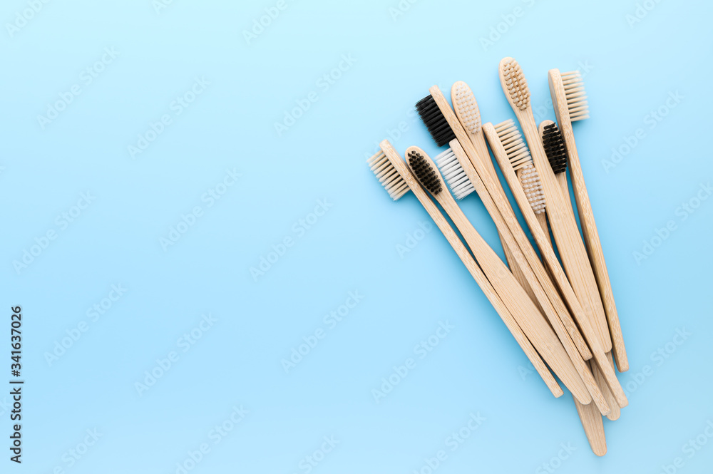 Zero waste and without plastic concept. Set of eco friendly bamboo toothbrushes on light pastel blue surface. Top view, copy space, horizontal orientation. Layout natural organic hygiene products. Zero waste and without plastic concept. Set of eco friendly bamboo toothbrushes on light pastel blue surface. Top view, copy space, horizontal orientation. Layout natural organic hygiene products.