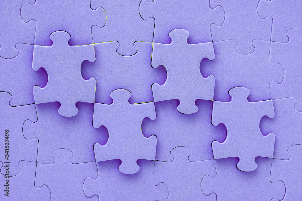 Close up of purple jigsaw puzzle background Close up of purple jigsaw puzzle background