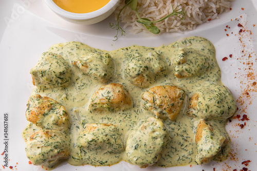 Chicken fillet in rice sauce on a white plate photo