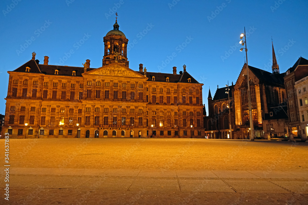 The Dam Square in Amsterdam Netherlands with the the Royal Palace at sunset