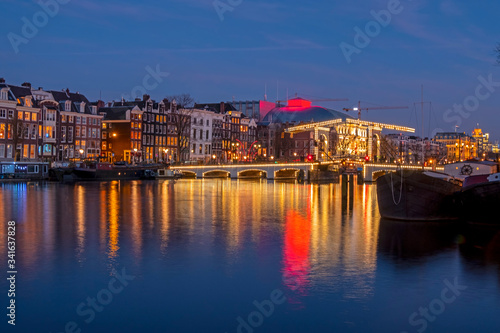 City scenic from Amsterdam at the river Amstel with the Tiny bridge in the Netherlands at night © Nataraj