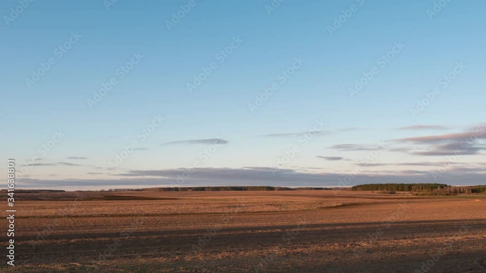 clouds floating over a field with crops at dawn clouds floating over a field with crops at dawn