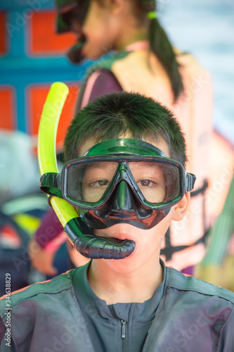 Portrait Asian Boy wearing a life jacket and scuba diving