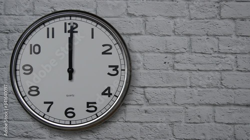 Wallpaper Mural The Time On The Clock Twelve. Clock With The Black Arrows With The Arabic Numerals On An White Brick Wall Background On The Left Side. Torontodigital.ca