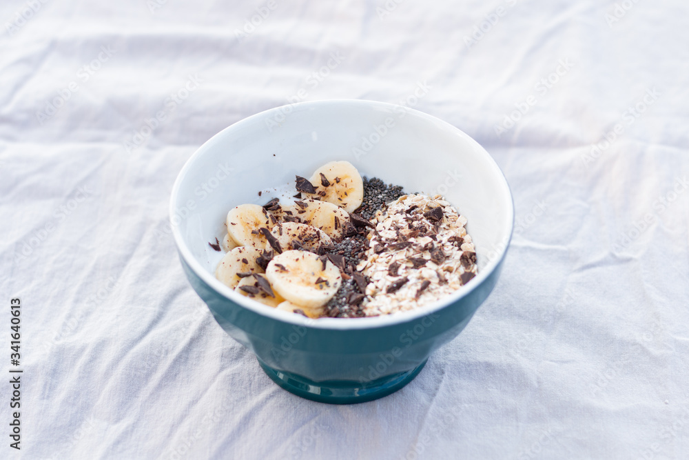 YOGURT BALL WITH BANANA OAT AND CHOCOLATE ON A WHITE BACKGROUND YOGURT BALL WITH BANANA OAT AND CHOCOLATE ON A WHITE BACKGROUND