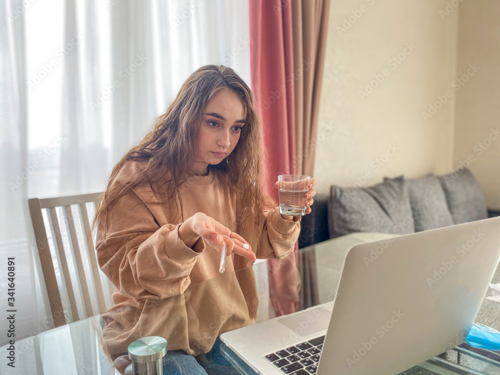 young modern woman consults a doctor online. Concept of outpatient treatment of coronavirus. young modern woman consults a doctor online. Concept of outpatient treatment of coronavirus.