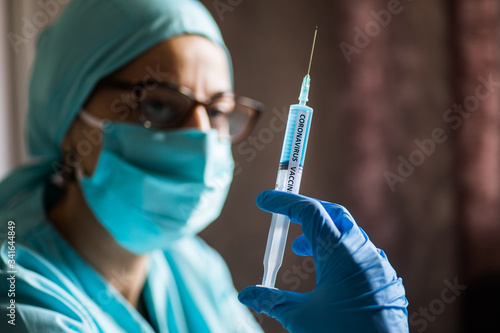 Nurse holding a syringe with the coronavirus COVID-19 vaccine