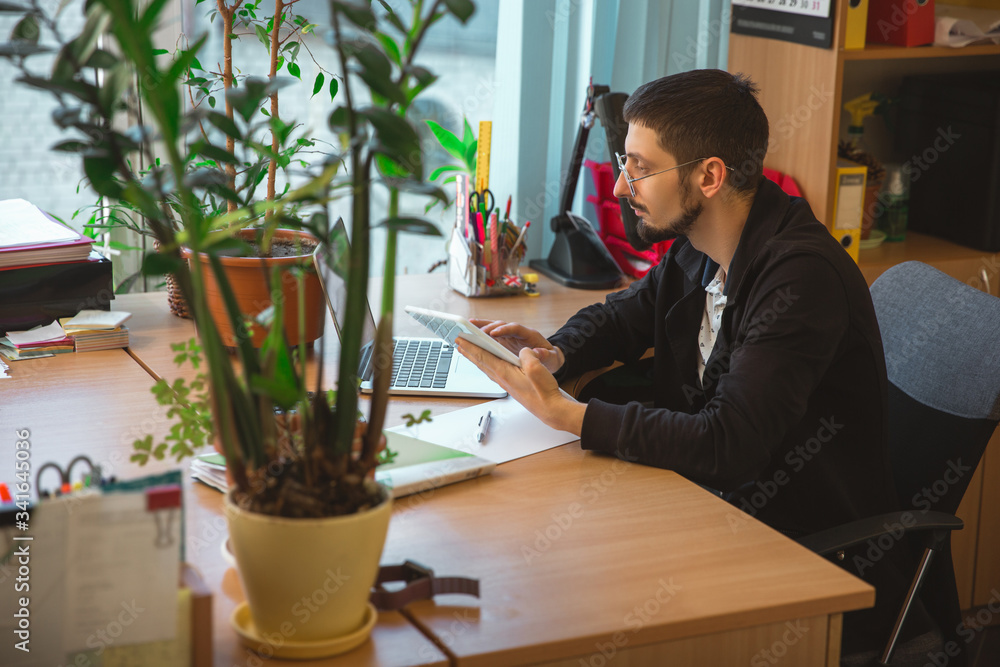 Using gadgets. Caucasian entrepreneur, businessman, manager working ...