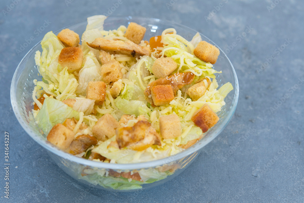 Caesar salad with toast, lettuce and grilled chicken breast and cheese Caesar salad with toast, lettuce and grilled chicken breast and cheese